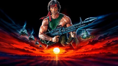 John Rambo v ikonické póze s kulometem a červenou šátkou na čele