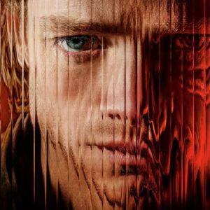 Zblízka tvář muže, jejíž pravá polovina se v červeném světle rozpíjí do deformované hmoty – promo obrázek k filmu Clayface